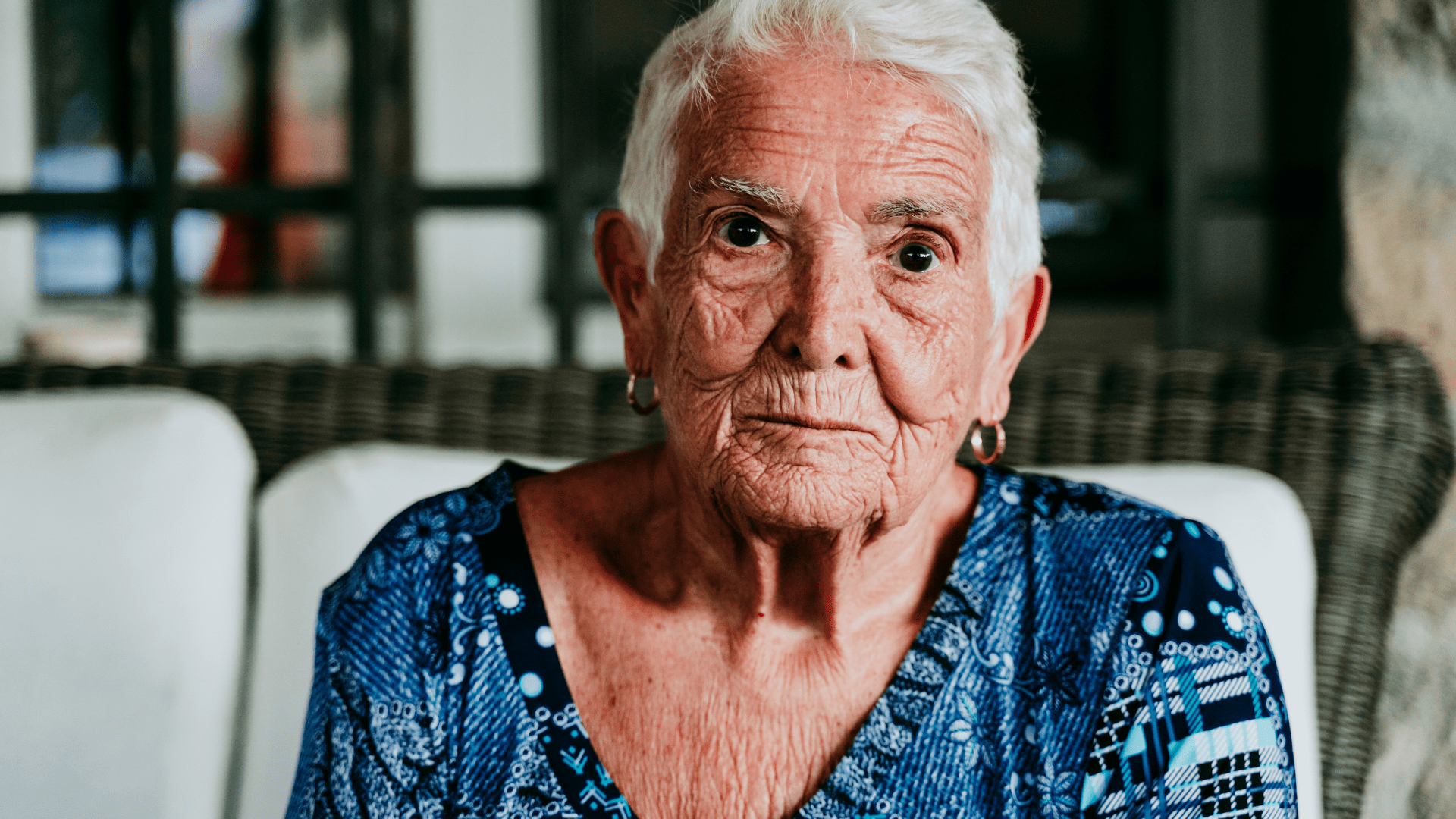 elderly woman sitting on a chair in old age home