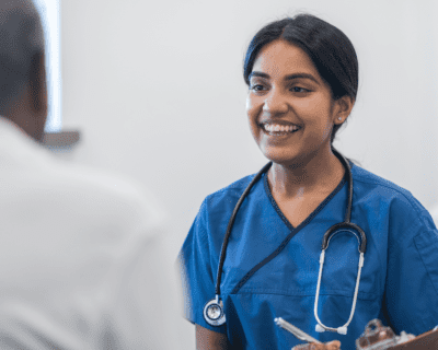 A nurse talking with an elderly