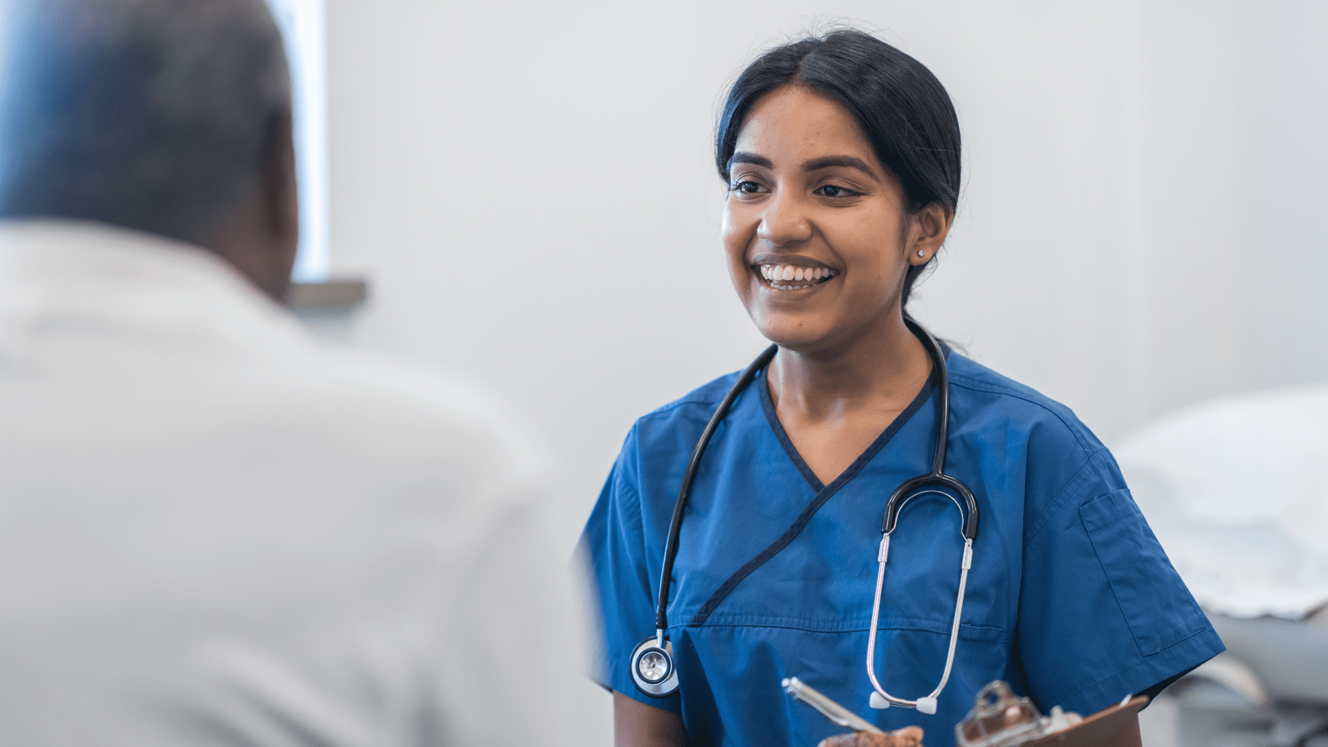 A nurse talking with an elderly